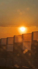 Sunset filmed through highway noise barrier in Kazan