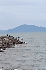 Morning fishing activity on Banda Aceh breakwater amid choppy seas