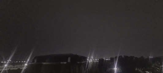 Tashkent night skyline with domed building under cloudy skies