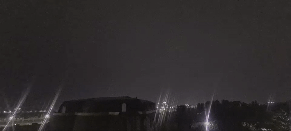 Tashkent night skyline with domed building under cloudy skies