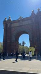 Sunny day at Barcelona's Arc de Triomf draws pedestrians
