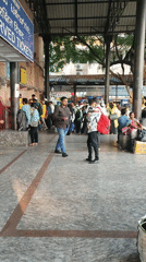 Busy train station activity observed near mechanical lion sculpture
