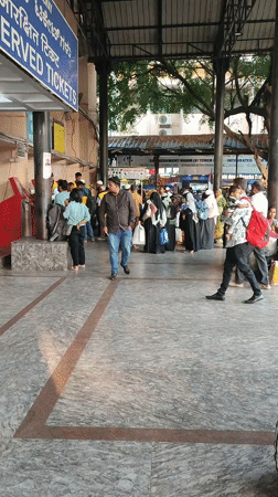 Busy train station activity observed near mechanical lion sculpture