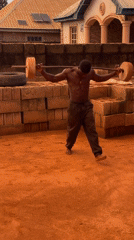 Man performs improvised weightlifting workout in Bukuru backyard