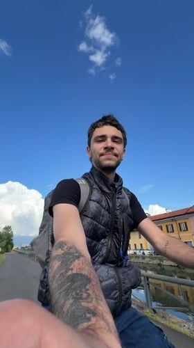 Cyclist travels scenic canal path in Bonirola, Italy