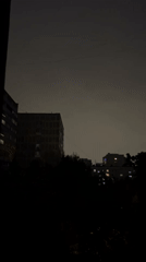 Thunderstorm strikes urban apartment district during evening hours