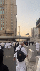 Crowds moving through a busy Makkah street