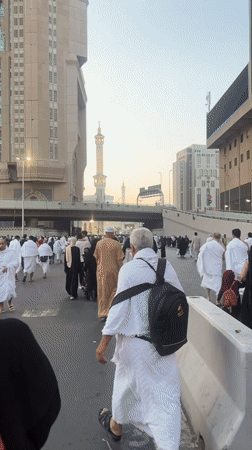 Crowds moving through a busy Makkah street