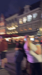 Live duo performance on a lit outdoor stage in Bruges