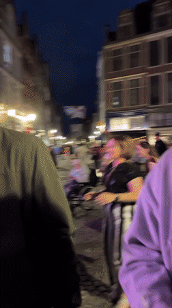 Live duo performance on a lit outdoor stage in Bruges