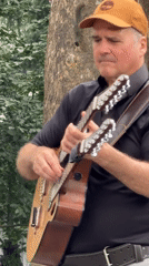 Live band playing in a New York park, mid-July afternoon