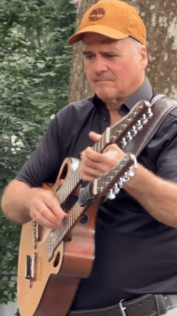 Live band playing in a New York park, mid-July afternoon