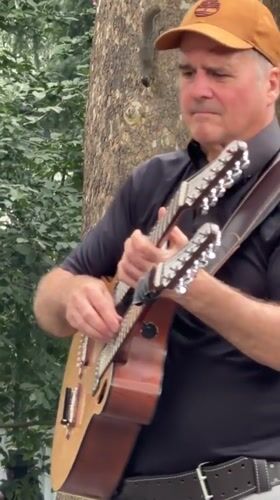Live band playing in a New York park, mid-July afternoon