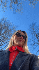 Woman films outdoor selfie video in sunny Riga