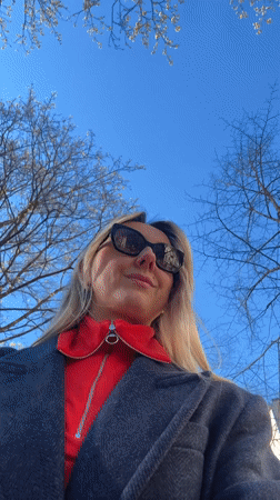 Woman films outdoor selfie video in sunny Riga