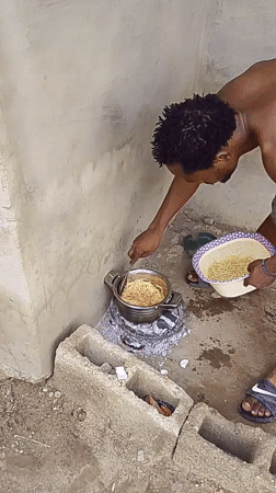 Man cooks spaghetti outdoors in Keffi, Nigeria residential area