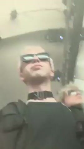 The video shows a transition from a dark red scene to a blurry shot of a person wearing sunglasses, and then back to a dark red scene. The last scene shows a crowd of people in a dark environment with red and white lights flashing.