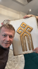 Man displays decorative art with poodle in Novosibirsk