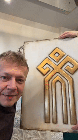 Man displays decorative art with poodle in Novosibirsk