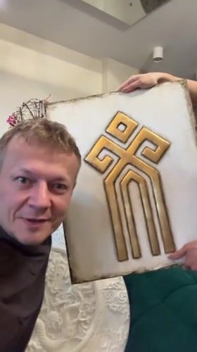 Man displays decorative art with poodle in Novosibirsk