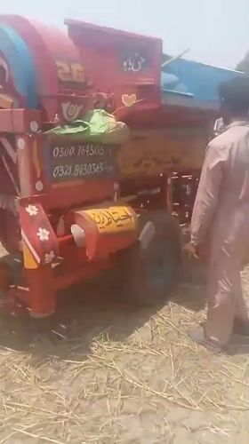 Morning farm work captured around threshing machine in Pakistan