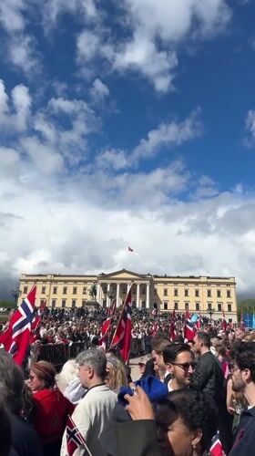 Crowds celebrate with flags at Oslo Royal Palace