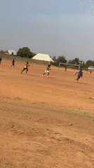 Soccer match on dirt field in Nigeria