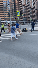 Daily life continues in Murino with pedestrians and delivery robots