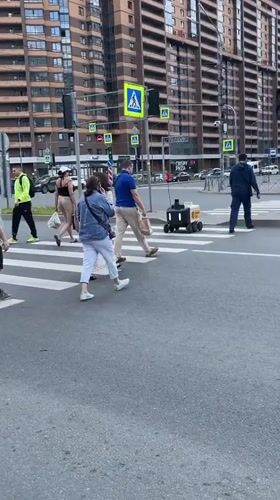 Daily life continues in Murino with pedestrians and delivery robots
