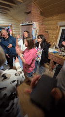 Family celebration with dancing observed in Russian cabin