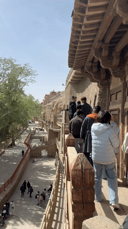Early morning tourist activity at Mogao Caves in Dunhuang