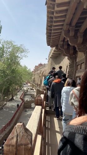 Early morning tourist activity at Mogao Caves in Dunhuang