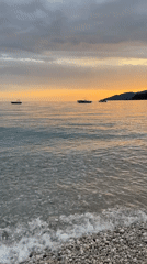 Woman swims at sunset beach in Fethiye, Turkey