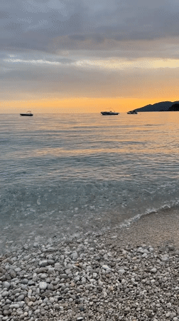 Woman swims at sunset beach in Fethiye, Turkey