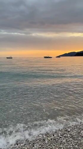 Woman swims at sunset beach in Fethiye, Turkey