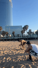 Men perform athletics, socialize on sunny Barcelona beach