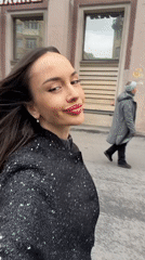 Woman in sequined jacket travels through Saint Petersburg streets