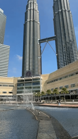 Early morning tourist activity at KLCC fountain, Kuala Lumpur