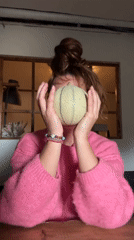 Woman holds cantaloupe at table in Wattrelos, France