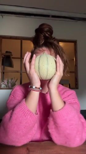 Woman holds cantaloupe at table in Wattrelos, France