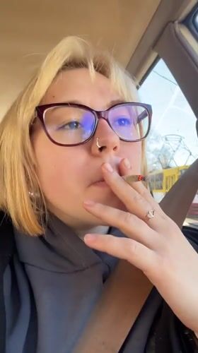 Woman smoking in passenger seat captured in Odesa vehicle