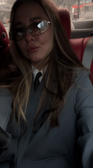 Woman in business attire photographed in car backseat, Yiwu