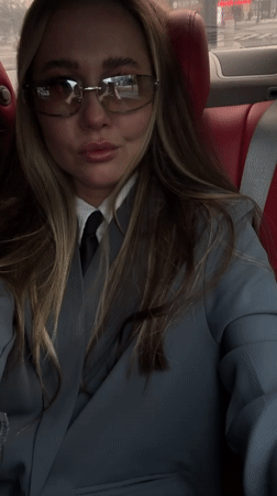 Woman in business attire photographed in car backseat, Yiwu