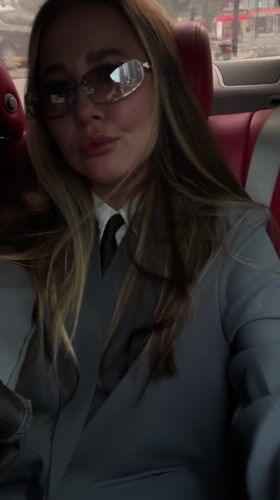 Woman in business attire photographed in car backseat, Yiwu