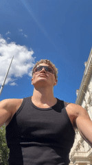 Low-angle portrait against a bright London summer sky