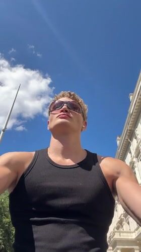 Low-angle portrait against a bright London summer sky