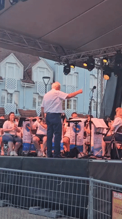 Brass ensemble performs under tented stage in Hévíz