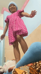 Girl in Barbie dress poses indoors in Gelam, Indonesia