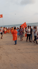 Orange flag procession draws crowds to Arambol beach