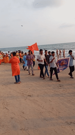 Orange flag procession draws crowds to Arambol beach